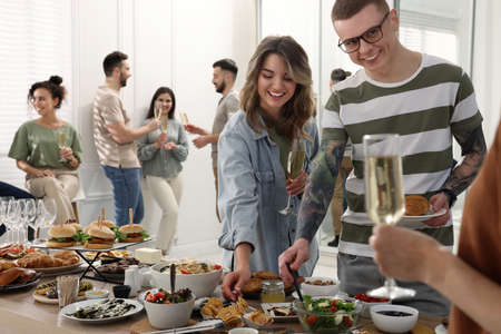 Group of people enjoying brunch buffet together indoorsの写真素材