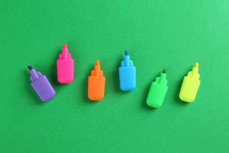 Many colorful markers on green background, flat lay. school stationeryの写真素材