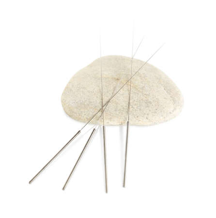 Many needles for acupuncture and stone on white background, top viewの写真素材