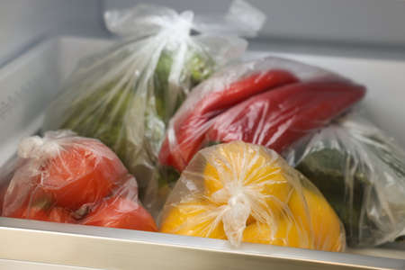 Plastic bags with different fresh products in refrigerator, closeupの写真素材