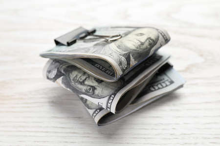 Many dollar banknotes on white wooden table, closeup. american national currency