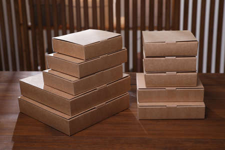 Stacked packaging boxes on wooden table indoors. production line