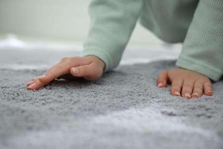 Woman touching soft gray carpet indoors, closeupの写真素材