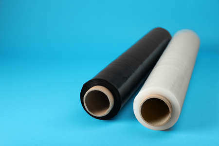 Rolls of different stretch wrap on turquoise background. Space for textの写真素材