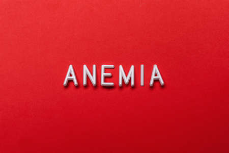 Word Anemia on red background, flat layの写真素材
