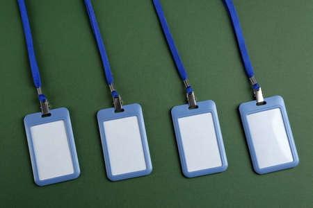 Blank badges on dark green background, flat lay. Mockup for designの写真素材
