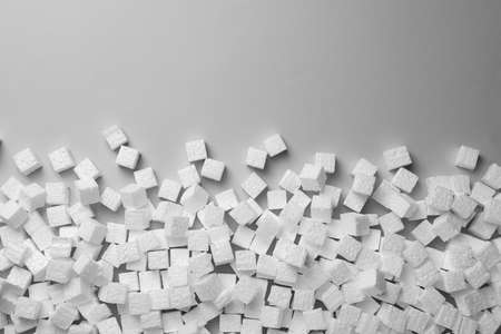 Many  foam cubes on gray background, flat lay. Space for textの写真素材