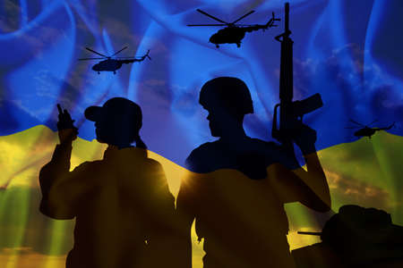Stop war in Ukraine. Silhouettes of defenders and military machinery. Double exposure of Ukrainian flag and skyの写真素材