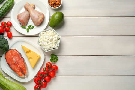 Flat lay composition with different fresh products on white wooden table, space for text. Keto dietの写真素材