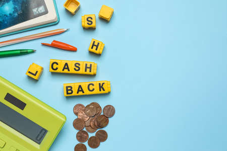 Word Cashback made with cubes, coins and calculator on light blue background, flat lay. Space for textの写真素材