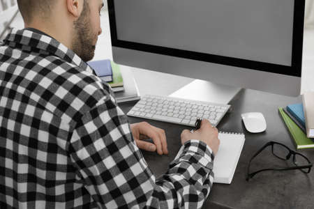 Young man using modern computer for studying indoors, closeup. distance learning