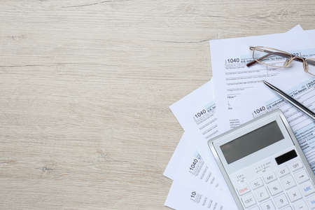 Calculator, documents, glasses and pen on white wooden table, flat lay with space for text. tax accountingの写真素材