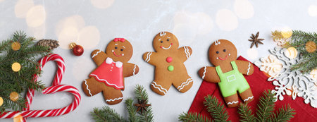 Flat lay composition with gingerbread cookies on light gray marble table. banner design