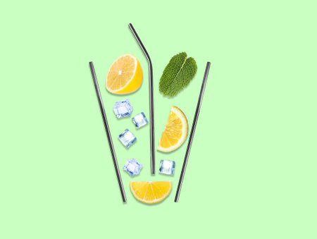 Creative lemonade layout with lemon slices, mint, ice cubes and straws on color background, top viewの写真素材
