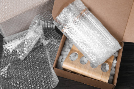 Test tubes in cardboard box and wrap on dark wooden table
