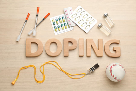 Flat lay composition with word Doping, baseball ball and drugs on wooden tableの写真素材