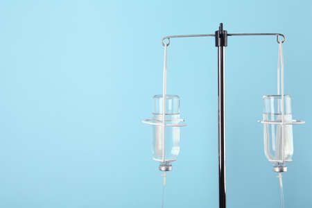 IV infusion set on light blue background. Space for text