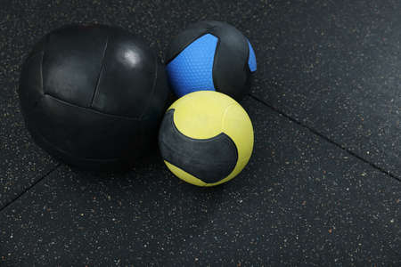 Many different medicine balls on black floorの写真素材