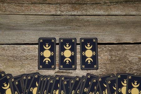 Tarot cards on wooden table, top view and space for text. reverse sideの写真素材