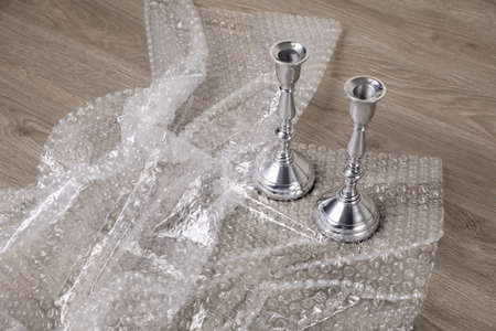 Candlesticks with bubble wrap on wooden table