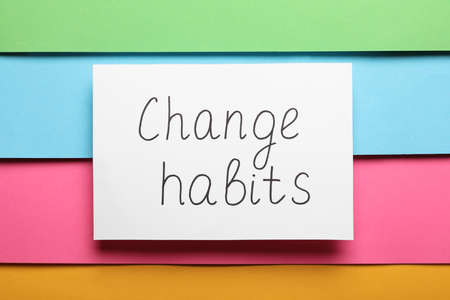 Paper note with phrase Change Habits on color background, top viewの写真素材