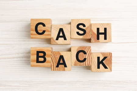Cubes with word Cashback on white wooden table, flat layの写真素材