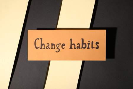 Paper note with phrase Change Habits on color background, top viewの写真素材
