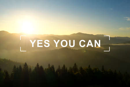 Yes You Can. Motivational quote inspiring to believe in yourself. Text against beautiful mountain landscape at sunriseの写真素材