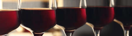 Glasses with tasty red wine, closeup view. banner designの写真素材