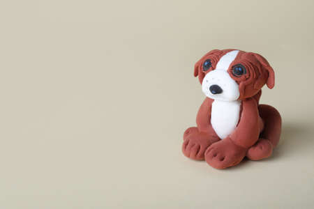 Small dog made from play dough on light gray background. Space for textの写真素材