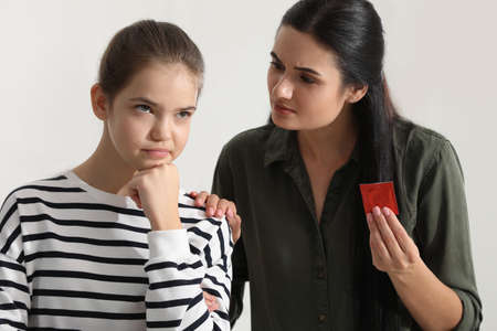 Mother talking with her teenage daughter about contraception at home. sex education conceptの写真素材