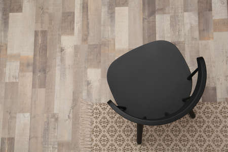 Stylish comfortable black chair on floor, top view. Space for textの写真素材