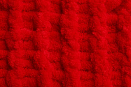 Soft red knitted fabric as background, top viewの写真素材
