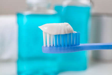 Toothbrush with paste near mouthwash on blurred background, closeupの写真素材