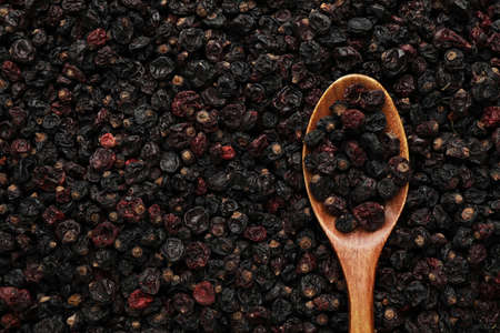 Spoon and tasty dried currants as background, top view. Space for textの写真素材