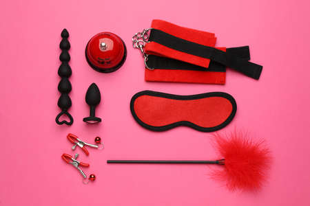 Sex toys and accessories on pink background, flat layの写真素材