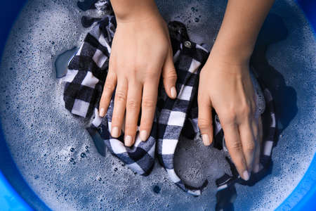Woman washing garment in basin, closeup. Laundryの写真素材