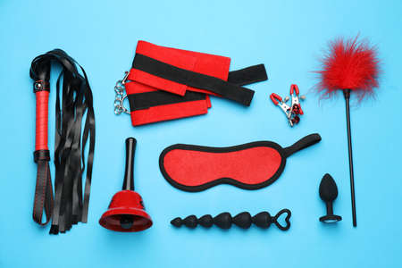 Sex toys and accessories on light blue background, flat layの写真素材