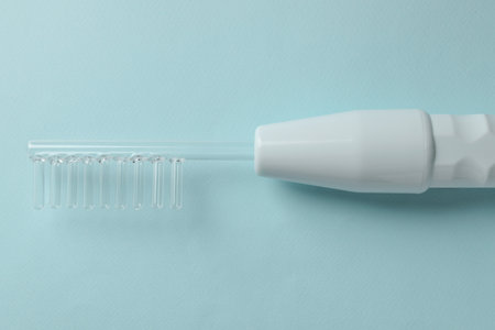 Darsonval on turquoise background, top view. modern device