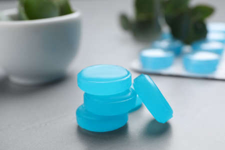 Many cough drops on light gray table, closeupの写真素材