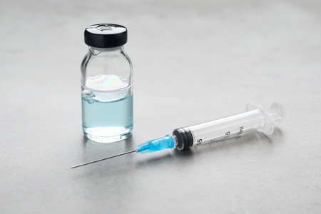 Syringe and vial on gray table. medical anesthesia