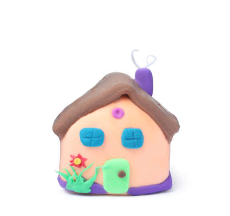 Small house made from play dough on white backgroundの写真素材