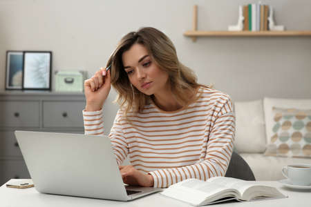 online test. Woman studying with laptop at home