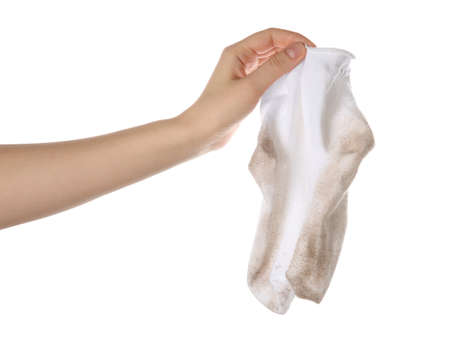 Woman holding dirty socks on white background, closeup