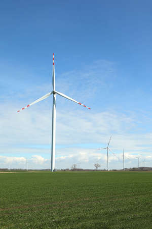 Modern wind turbines in field on sunny day. alternative energy sources