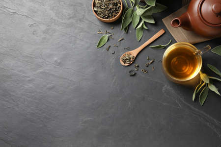 Flat lay composition with aromatic sage tea on black table. Space for textの写真素材