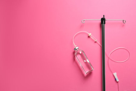 IV infusion set on pink background, flat lay. Space for textの写真素材