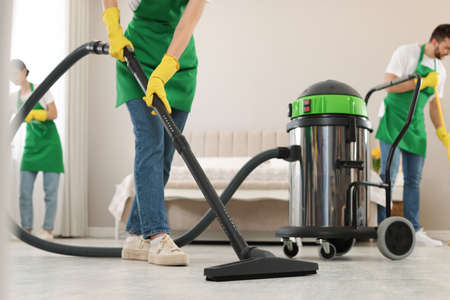 Team of professional janitors working in bedroom, closeupの写真素材