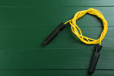 Skipping rope on green wooden table, top view. Space for textの写真素材