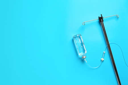 IV infusion set on light blue background, flat lay. Space for textの写真素材